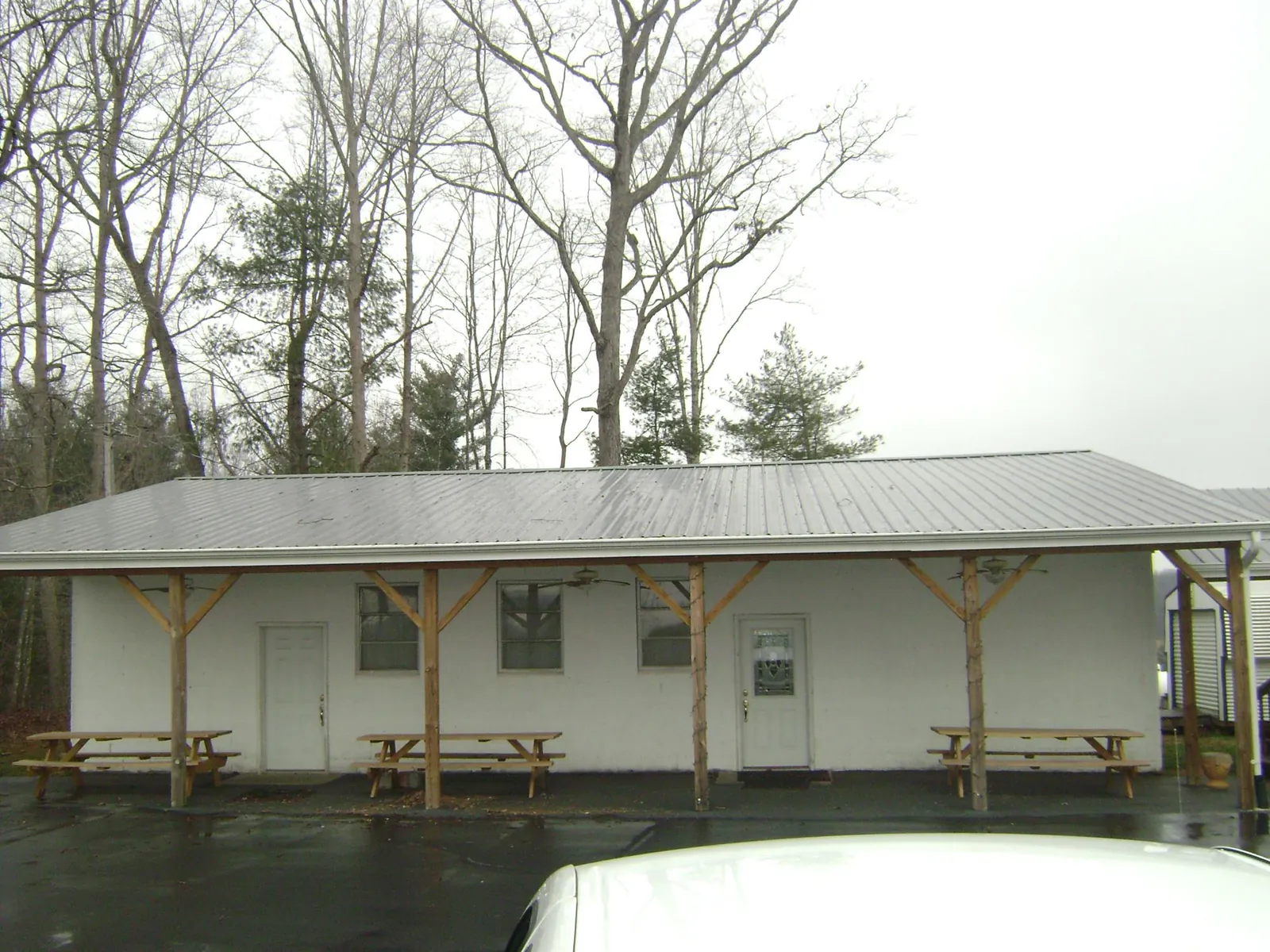 Gray metal roof over a block building with a timber post porch in Silver Creek